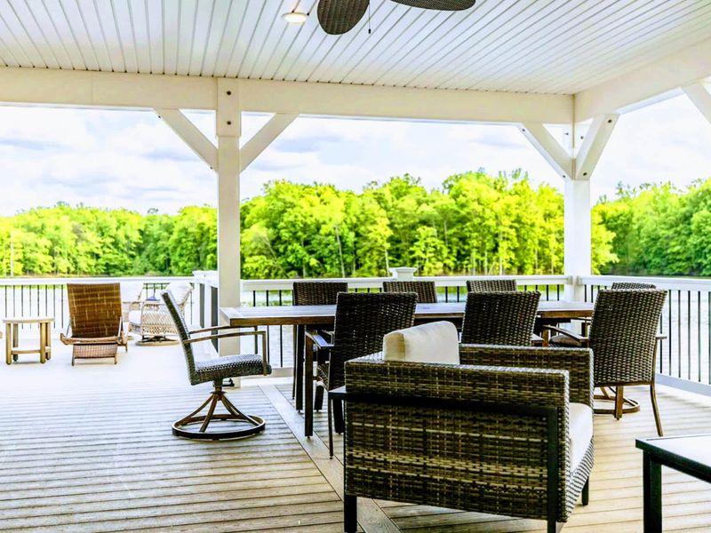 Relax in our outdoor lounge area with ample seating on the covered deck, offering serene views of the lake and lush surroundings