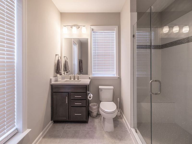 Refresh and rejuvenate in our modern in-law bathroom featuring a spacious walk-in shower, elegant vanity, and ample natural light