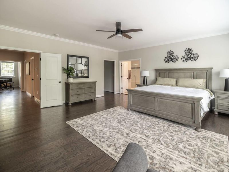 Unwind in the spacious elegance of our Primary Bedroom featuring a comfortable king-size bed and serene views
