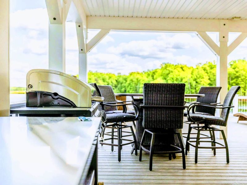 Grill to your heart's content in our outdoor kitchen area while enjoying the scenic lake views from the comfort of modern patio seating