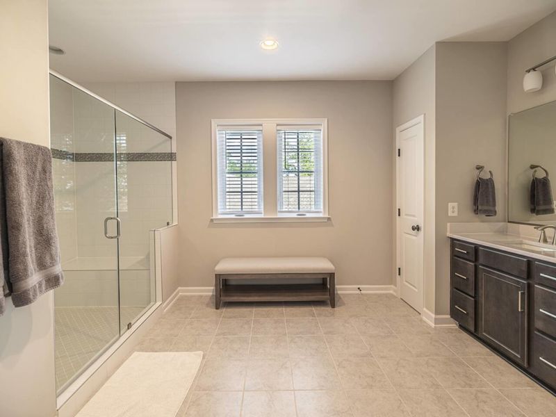 Enjoy the comfort and elegance of a modern en-suite bathroom with a spacious walk-in shower and plenty of natural light