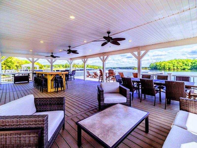 Relax in our covered outdoor lounge with ample seating, perfect for entertaining or unwinding by the lake!