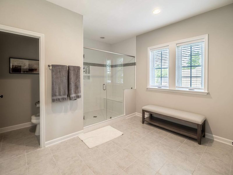 Enjoy the comfort and elegance of a modern en-suite bathroom with a spacious walk-in shower and plenty of natural light