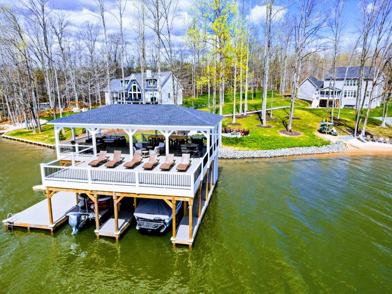 Your family will enjoy our large private lakefront lot with ~300' of waterfront property, a private sandy beach, amazing private 2 story dock and boat house with large comfy lounge area for re