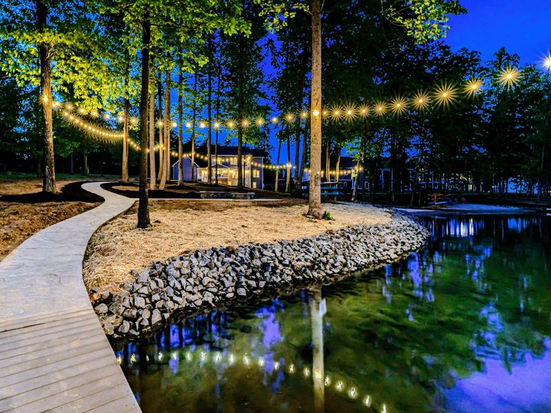 Stroll along the illuminated pathway to our enchanting lakeside retreat, where magical evenings under the fairy lights await you!