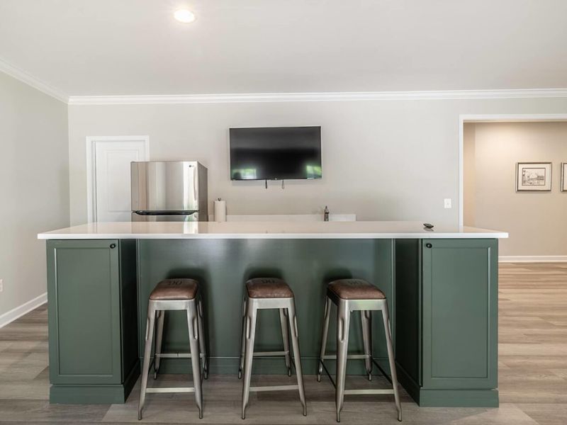 Sip and savor your favorite beverages at our sleek in-house bar area, equipped with modern stools and a mounted TV for your entertainment!