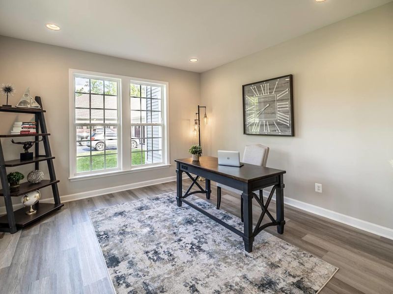 Enjoy a peaceful and productive atmosphere in our bright home office space, framed by large windows that let in plenty of natural light