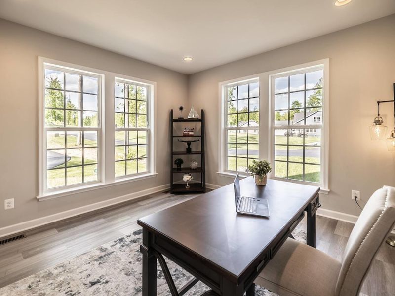 Stay productive remotely in our bright home office space, featuring a large desk, comfortable seating, high-speed internet, and plenty of natural light!