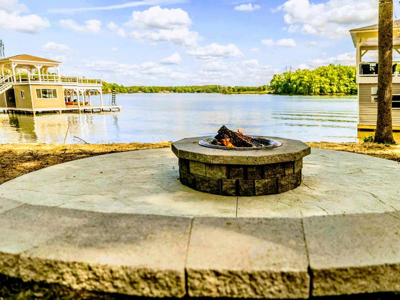 Relax and toast marshmallows around the outdoor fire pit, offering a cozy spot for evening chats and serene lake views!