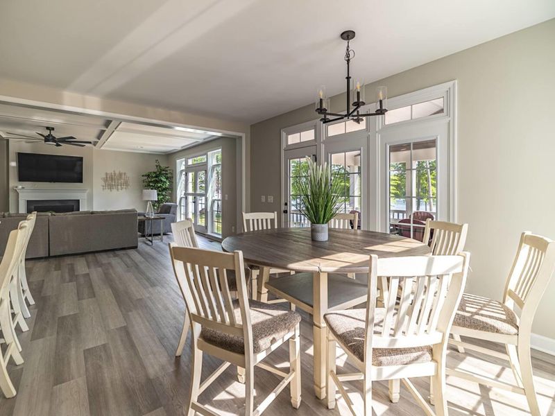 Gather around the beautifully crafted real wood table that comfortably seats 7, seamlessly adjacent to the kitchen, creating a warm and inviting space for shared meals and memorable conversations!