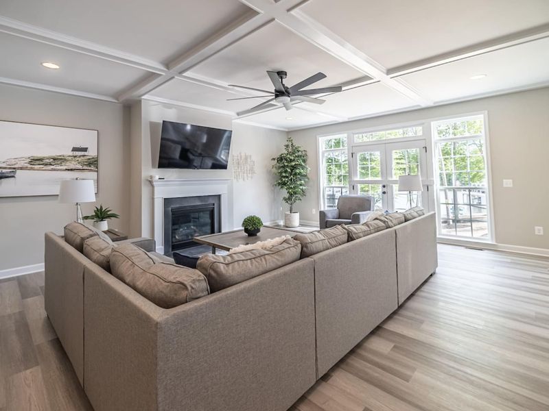 Open living room with an amazing view of lake Anna, comfy couch, 4K Smart TV, and gas fireplace!