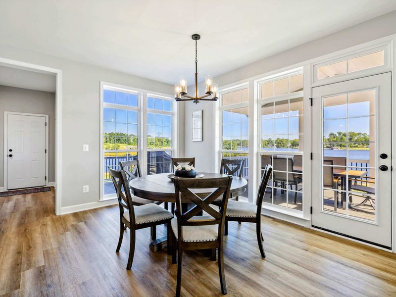 Bright dining area with large windows and patio access offering stunning views of the lake