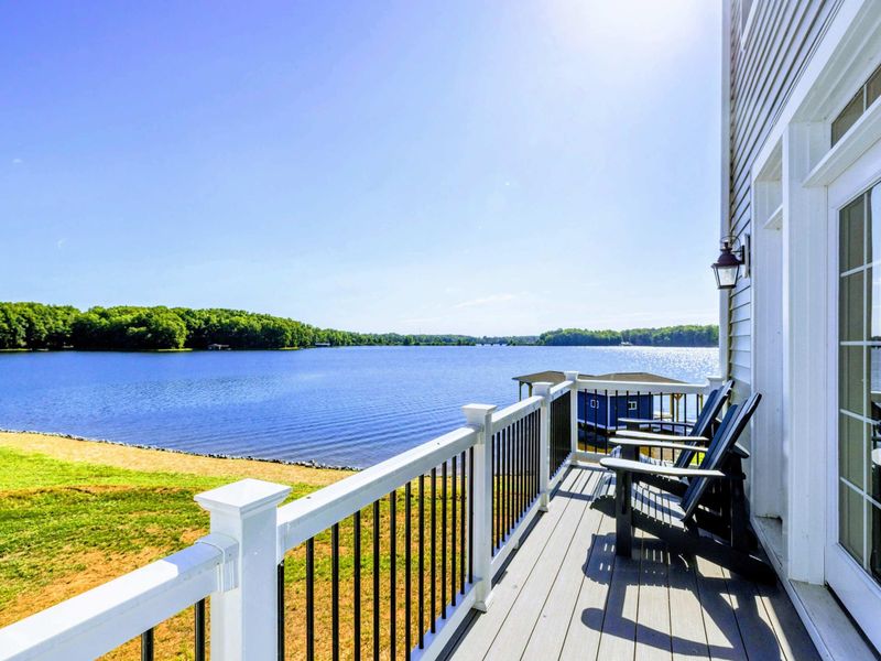 Private balcony with seating and stunning views of the lake, perfect for relaxing