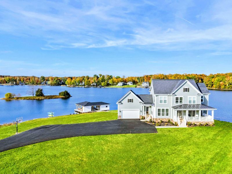 A beautiful lakefront home with expansive views, a private boathouse, and a spacious yard for outdoor activities