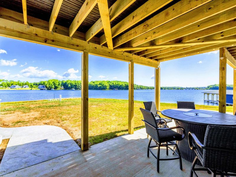 Covered patio with outdoor dining and stunning lake views for a perfect al fresco experience