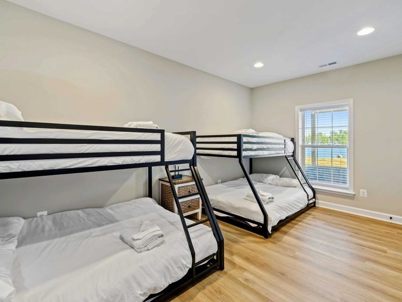 Bright and airy room featuring two bunk beds, ideal for kids or group stays