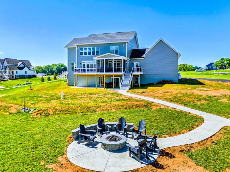 Spacious home with a large backyard and a cozy fire pit area, perfect for outdoor gatherings