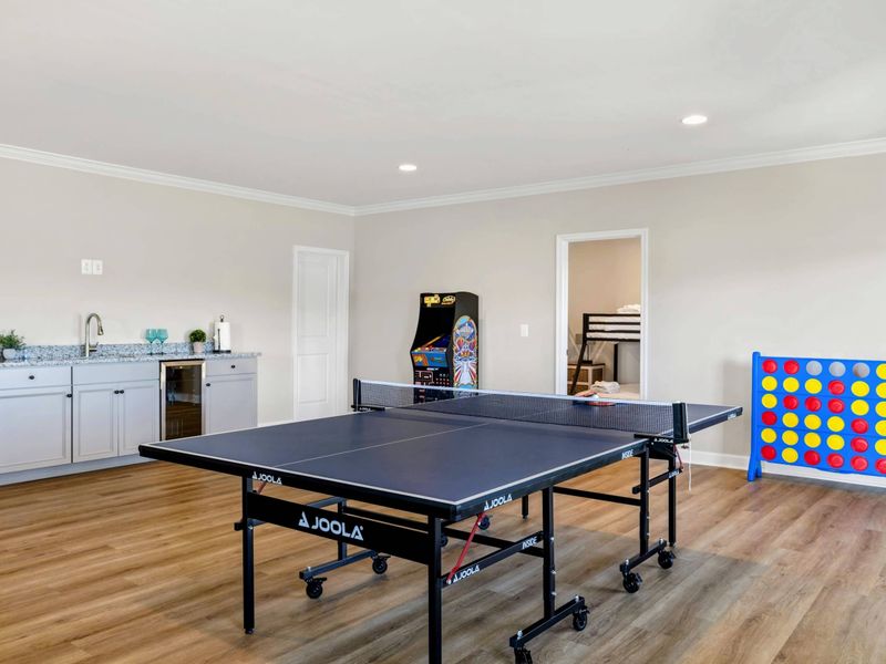 Enjoy our well-equipped game room featuring a ping pong table, arcade machine, Connect Four, and a convenient wet bar for refreshments.