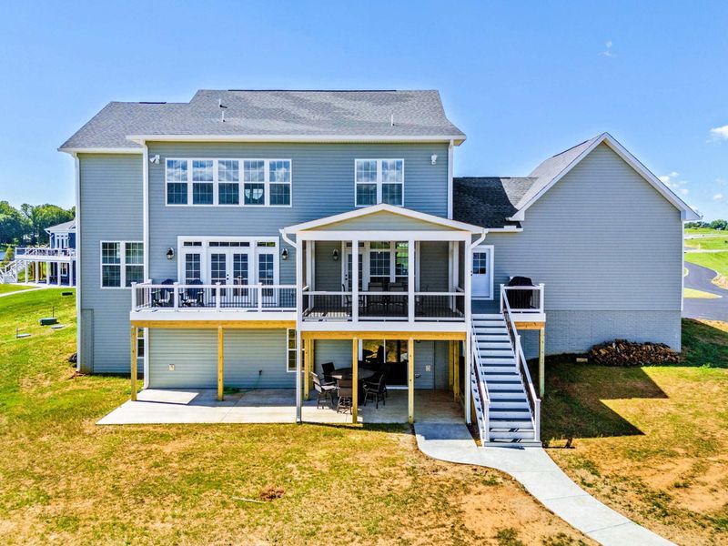 pacious lakeside home with multiple decks and a patio for outdoor dining and relaxation
