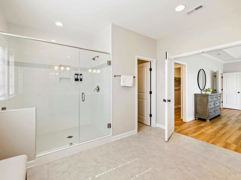 Luxurious en-suite bathroom with a large glass-enclosed shower and direct access to the Primary Bedroom
