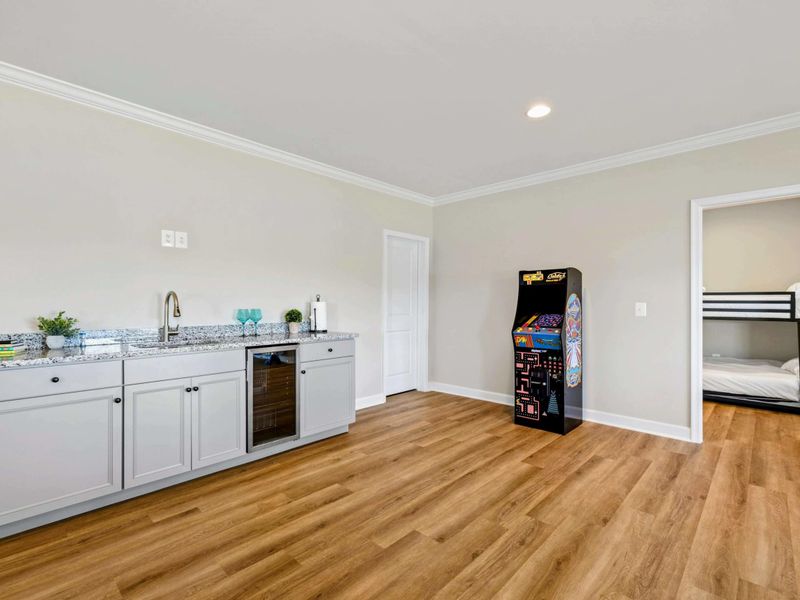 Our inviting game room includes a convenient wet bar and an arcade machine, perfect for entertainment and relaxation.