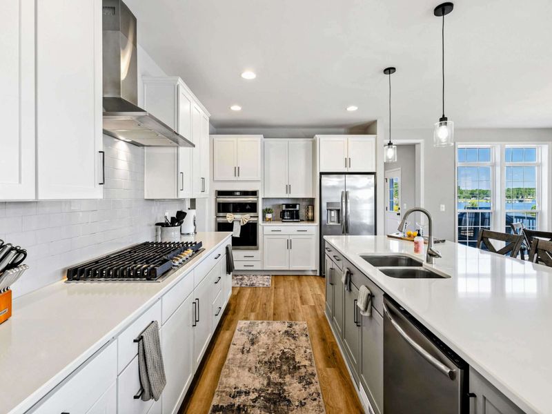 Our chef's kitchen boasts a sleek design with modern appliances, ample counter space, and a large island perfect for cooking and socializing.