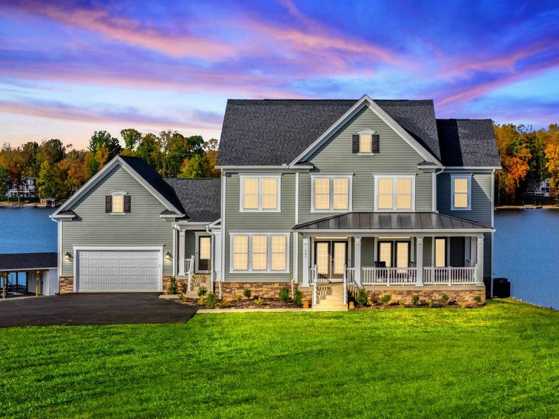 A stunning lakefront house with a spacious front porch, modern design, and direct water access