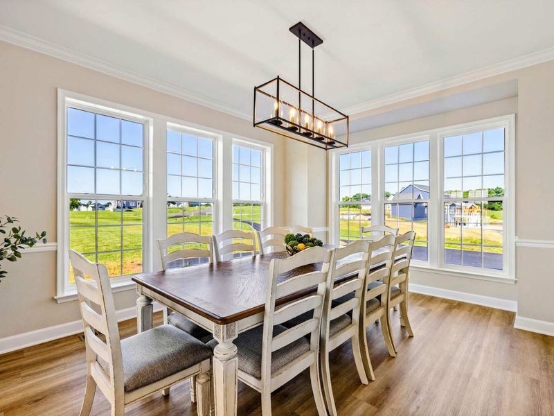 Elegant dining room with large windows offering plenty of natural light and a view of the outdoors