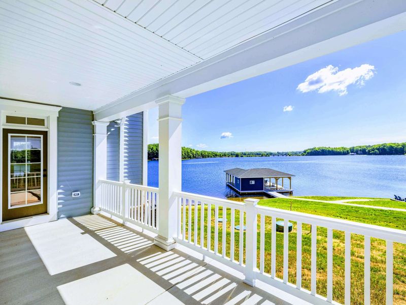 Enjoy serene lake views from the comfort of this spacious porch