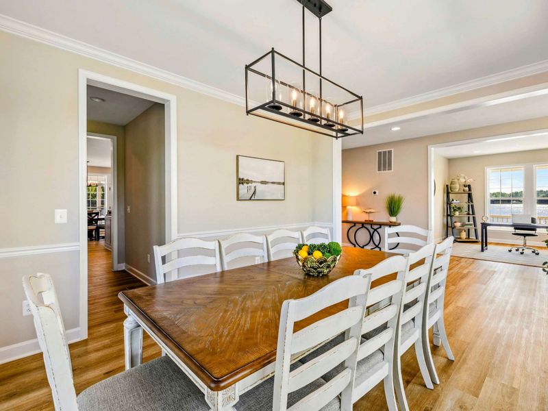 Spacious dining room with elegant decor, modern lighting, and easy access to the living area