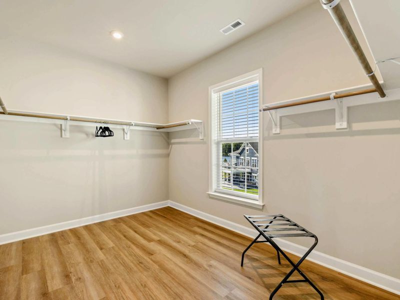 Spacious walk-in closet with ample hanging space and natural light