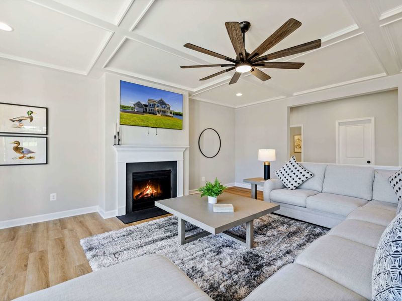 Our inviting living room features a large sectional, a cozy fireplace, a big-screen TV, and stylish decor for ultimate relaxation.