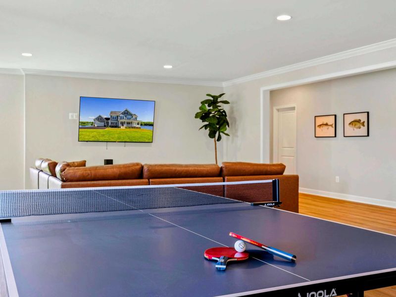 Entertainment area featuring a ping pong table and a large TV.