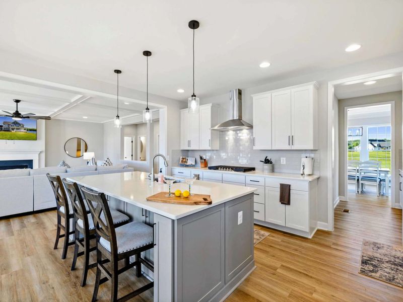 Our spacious, open-concept kitchen features a large island, modern appliances, and flows seamlessly into the living and dining areas, perfect for gatherings.