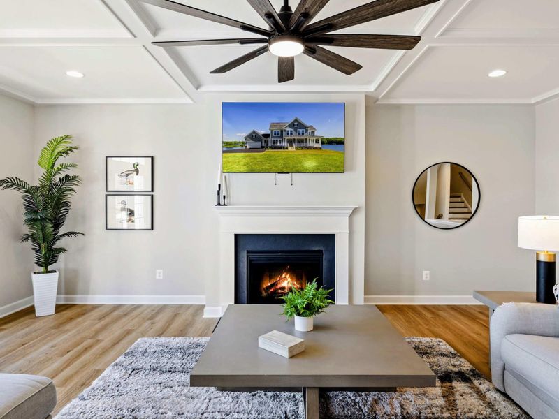 Unwind in our stylish living room, featuring a cozy fireplace, large TV, and modern decor.
