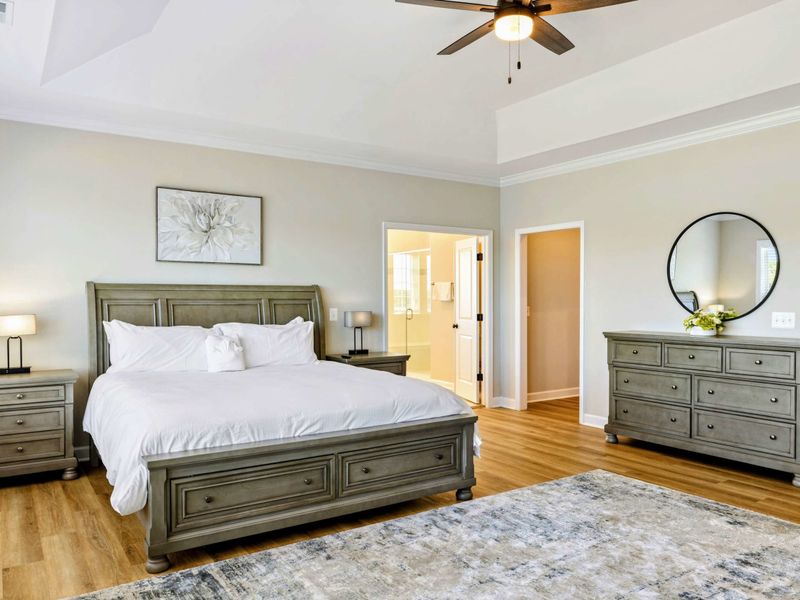 Luxurious Primary Bedroom with a king-size bed, stylish furnishings, and en-suite bathroom access