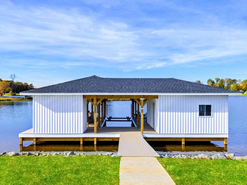 A charming lakeside boathouse with a spacious covered dock and serene water views