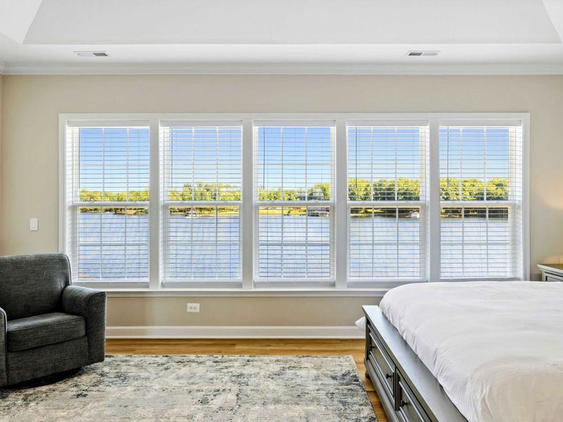 Primary Bedroom with panoramic lake views through large windows