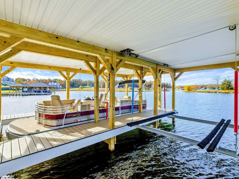 A covered boat slip wiith beautiful lake access