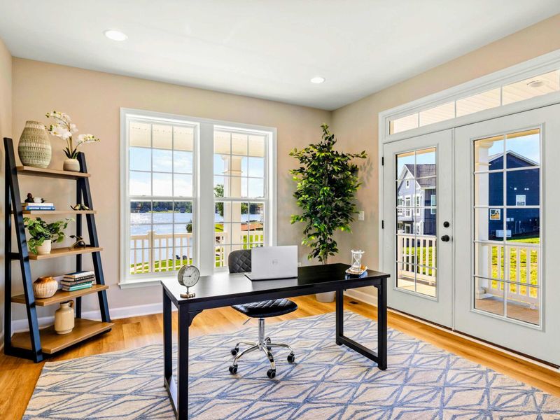 Bright and inviting home office with a serene lake view and direct access to the outdoor deck