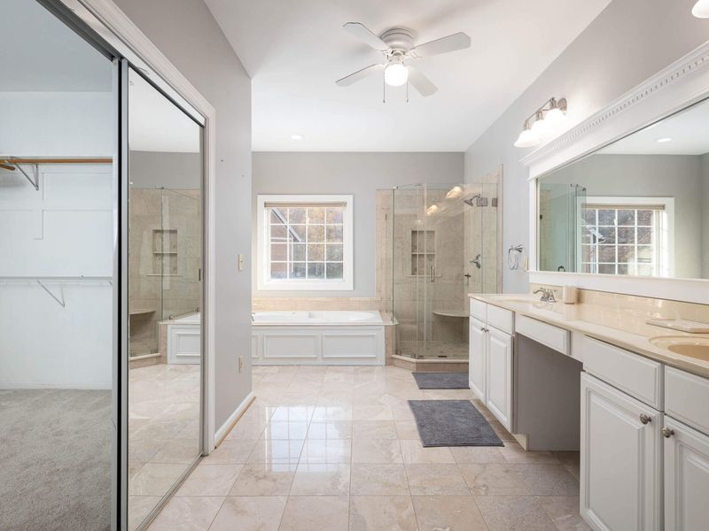 En suite bathroom w/jacuzzi tub and separate shower for primary bedroom on main level.