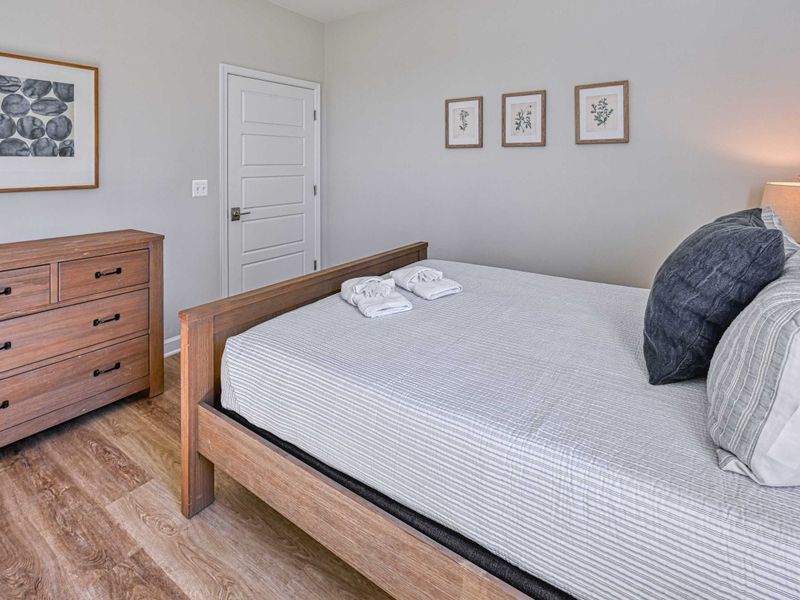 Make Yourself at Home – Fresh linens, warm wood tones, and a bedroom that instantly feels welcoming.