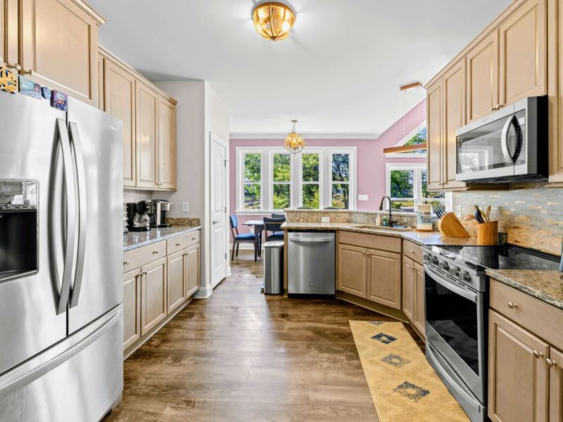 Kitchen - Galley flow with French-door refrigerator, full-size dishwasher, and prep-friendly counters on every side.