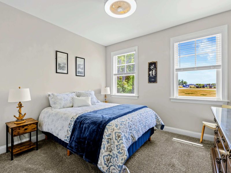Bedroom 3 - Queen bed with blue paisley bedding, anchor-themed nightstand lamps, and a relaxed nautical feel.