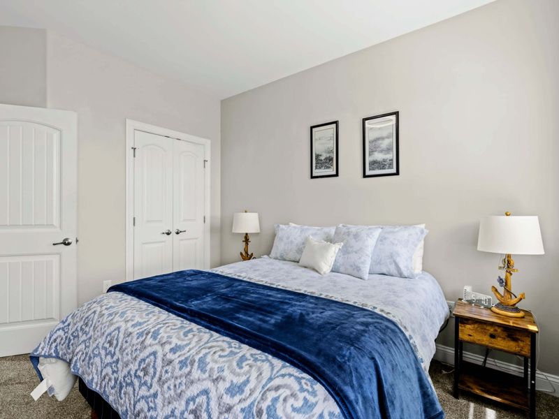 Bedroom 3 - Bed alongside the closet with a quiet bedside lamp.