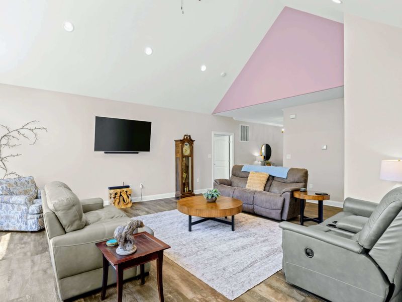 Living Room - Vaulted ceiling and warm wood floors set the scene for unwinding after a day on the lake.