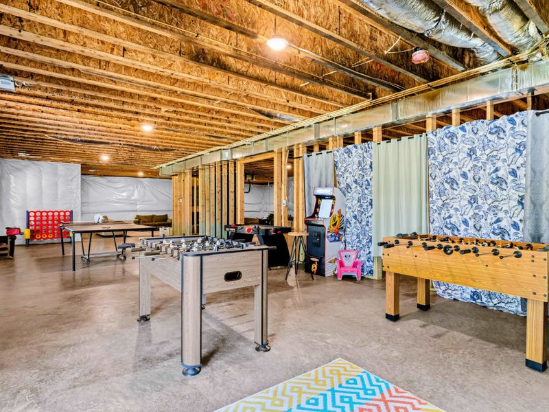 Game Room - Throwback arcade cabinet and foosball table headline a casual basement game zone.