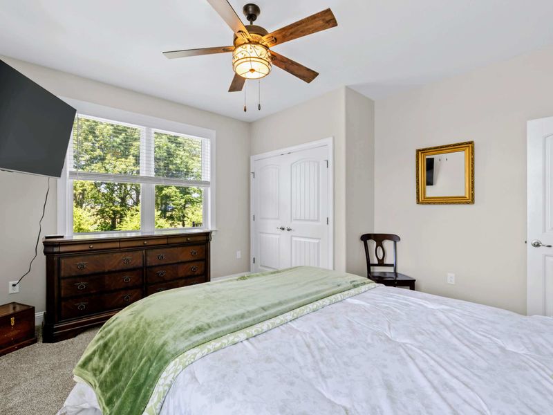 Bedroom 2 - Antique dresser, single double-hung window, and a quiet wood chair complete a restful retreat.