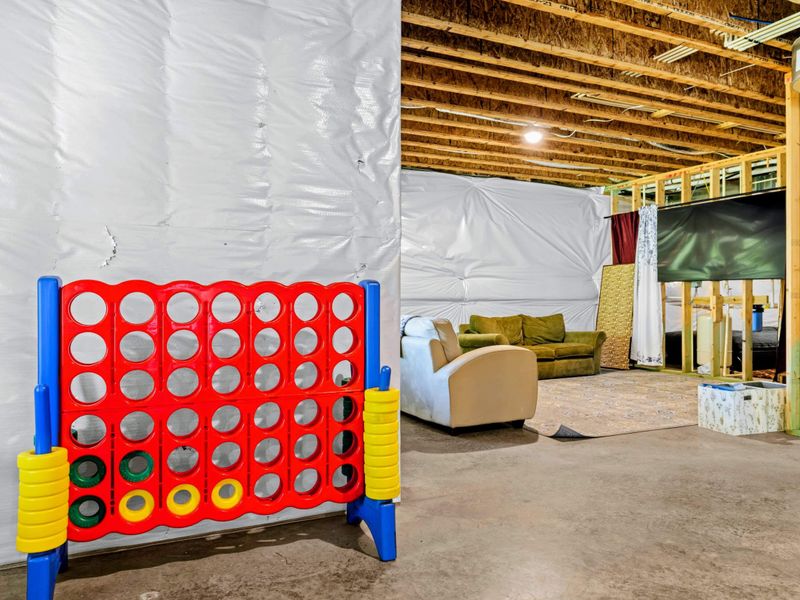 Lower Level - Giant Connect 4 and a casual seating zone, with the TV area just beyond.