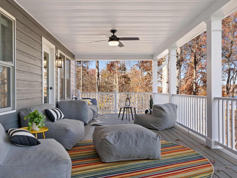 Covered Deck - Plush lounge seating, colorful pillows, and ceiling fans make this wraparound porch a favorite spot to unwind.